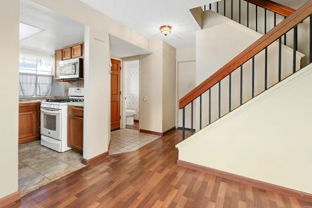 a view of a kitchen with an entryway and wooden floor