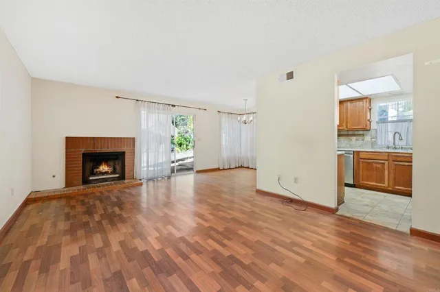 a view of a room wooden floor and a kitchen