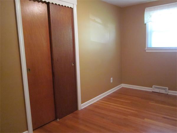 34 Redden Road Springfield, MA 01119 - Photo 12 of 20 an empty room with wooden floor and windows