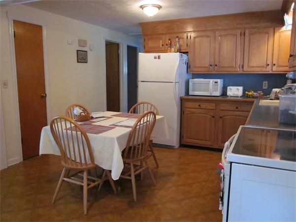 34 Redden Road Springfield, MA 01119 - Photo 2 of 20 a kitchen with a table chairs refrigerator and a sink