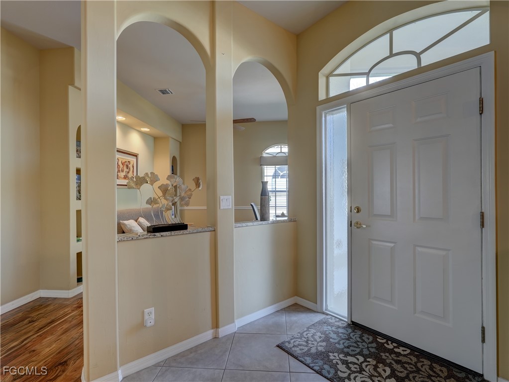 11180 Wine Palm Road Fort Myers, FL 33966 - Photo 12 of 40 a view of a hallway view with wooden floor and dining room view