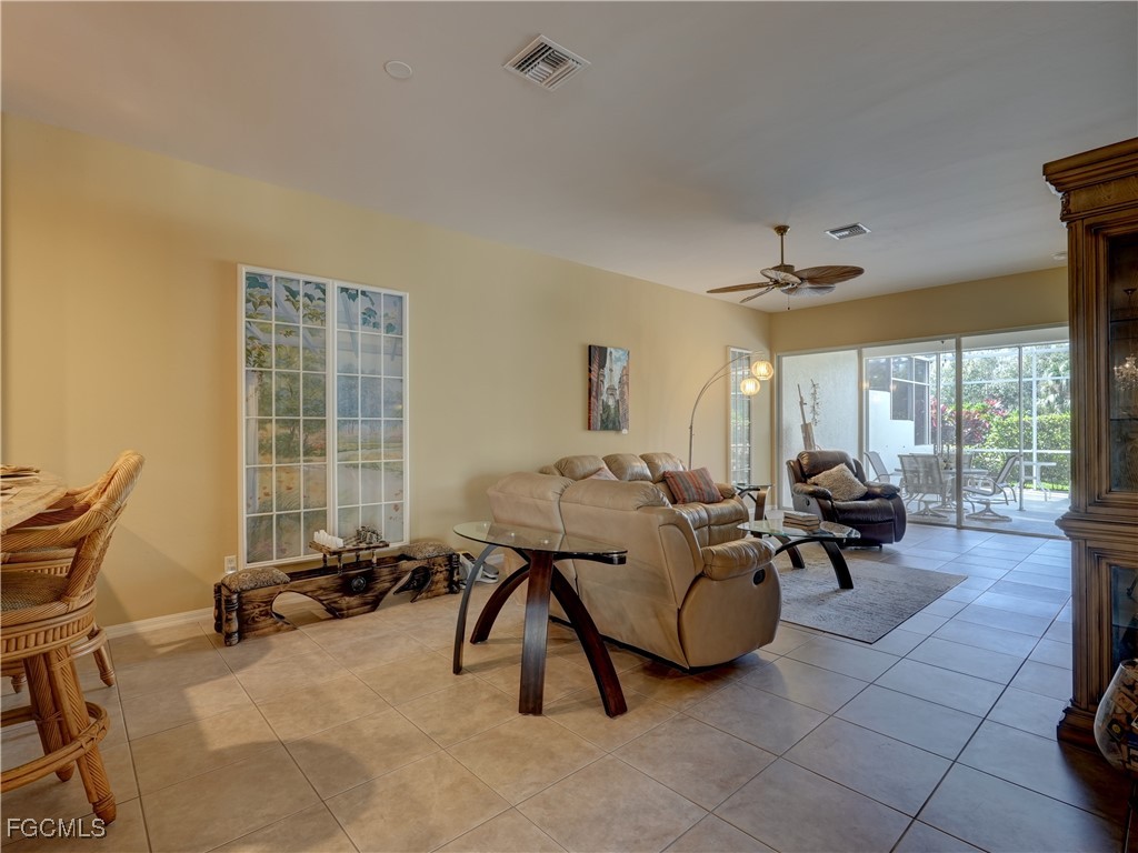 11180 Wine Palm Road Fort Myers, FL 33966 - Photo 17 of 40 a living room with furniture and a large window
