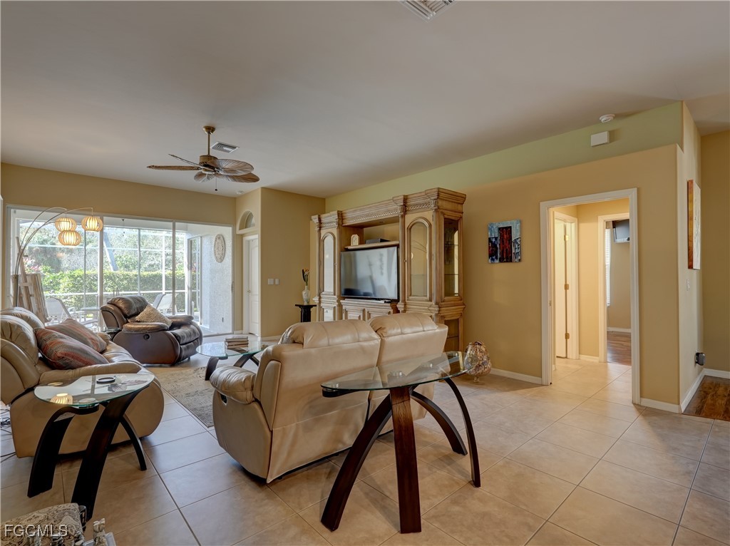 11180 Wine Palm Road Fort Myers, FL 33966 - Photo 19 of 40 a living room with furniture and a large window
