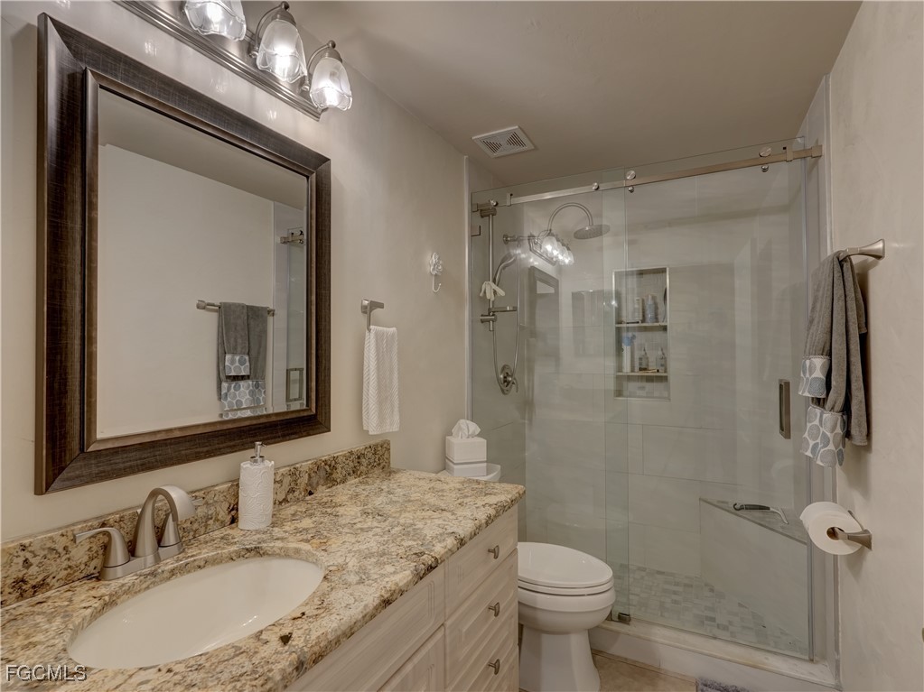 11180 Wine Palm Road Fort Myers, FL 33966 - Photo 21 of 40 a bathroom with a granite countertop sink toilet and shower