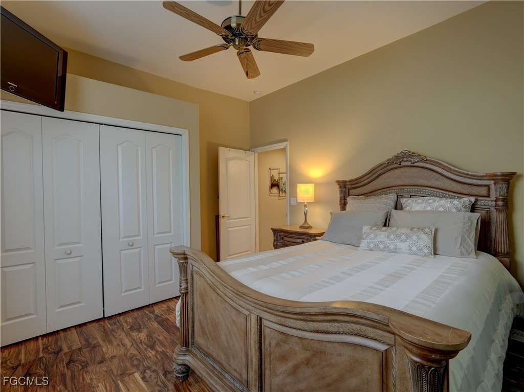 11180 Wine Palm Road Fort Myers, FL 33966 - Photo 23 of 40 a bedroom with a bed and a chandelier