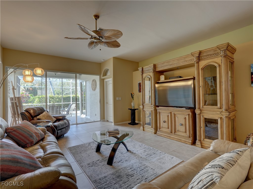 11180 Wine Palm Road Fort Myers, FL 33966 - Photo 24 of 40 a living room with furniture a ceiling fan and a large window