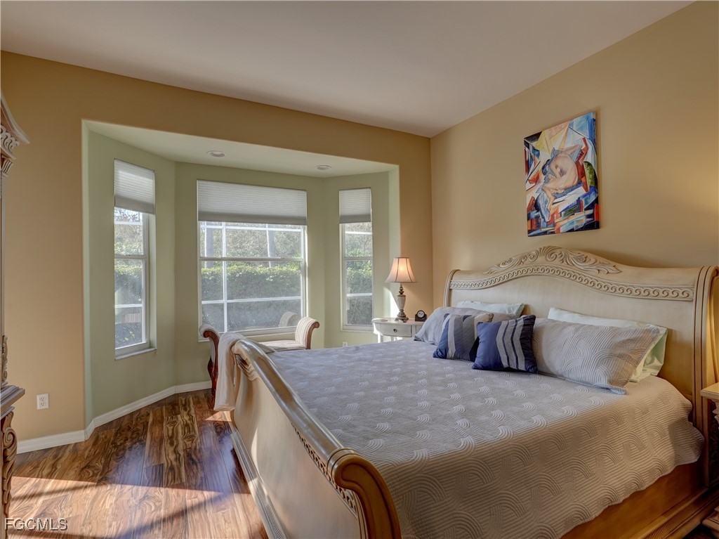 11180 Wine Palm Road Fort Myers, FL 33966 - Photo 25 of 40 a bedroom with a bed and a large window