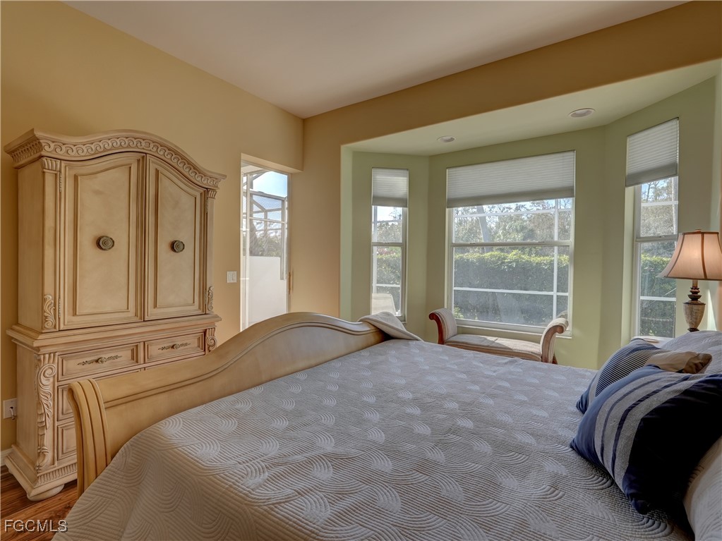 11180 Wine Palm Road Fort Myers, FL 33966 - Photo 26 of 40 a spacious bedroom with a bed and glass window