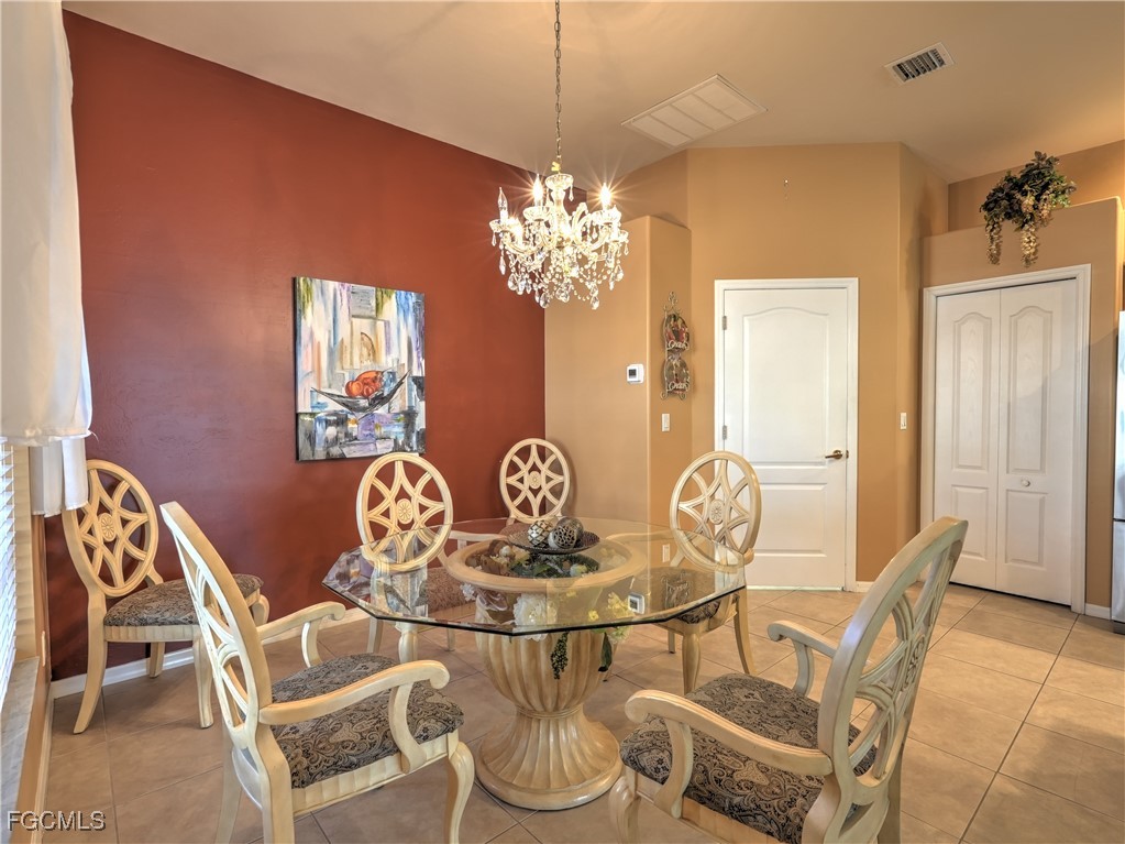 11180 Wine Palm Road Fort Myers, FL 33966 - Photo 4 of 40 a dining room with furniture and chandelier