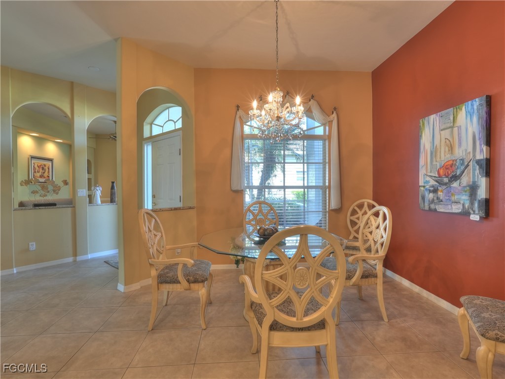 11180 Wine Palm Road Fort Myers, FL 33966 - Photo 5 of 40 a view of a dining room with furniture and chandelier