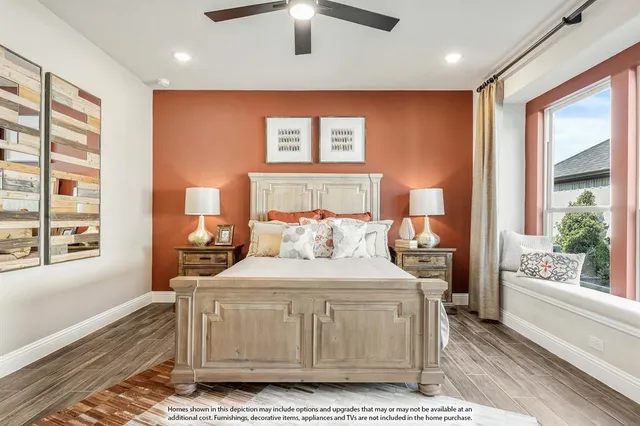 a bedroom with a large bed and a large window