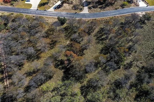 an aerial view of house with yard and ocean view