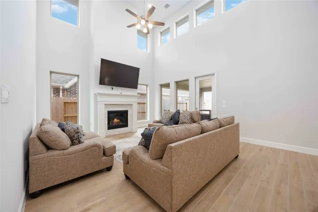 a living room with furniture a flat screen tv and a fireplace