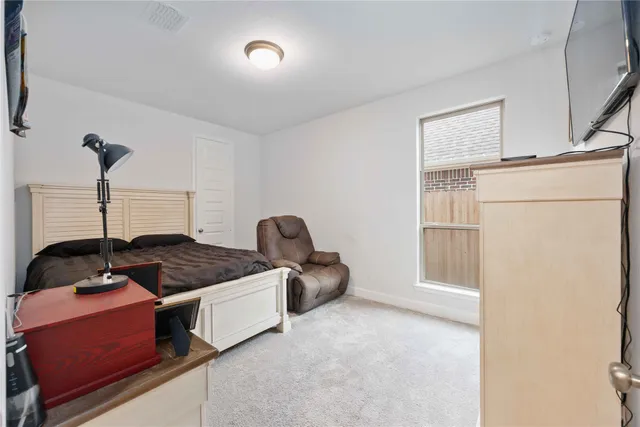 a bedroom with furniture and a window
