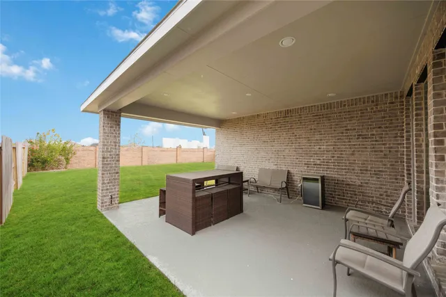 a view of a patio with a yard