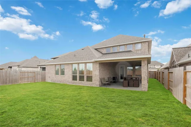 a view of a house with a yard and sitting area