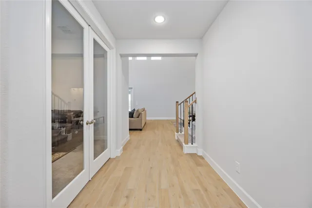 a view of a room with wooden floor