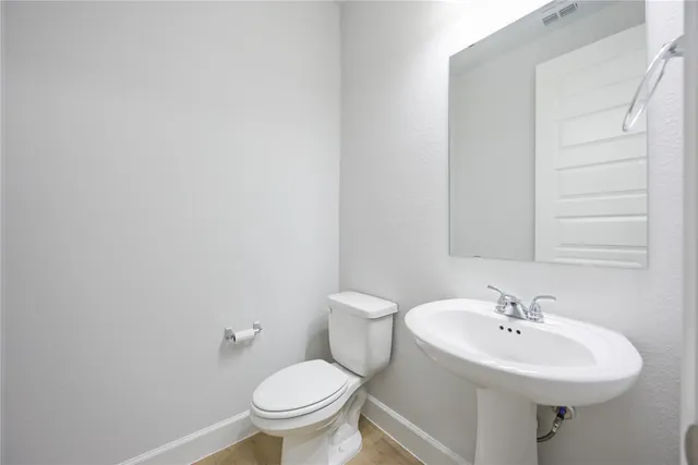 a bathroom with a sink a toilet and mirror