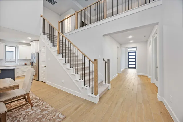 a view of entryway and hall with wooden floor