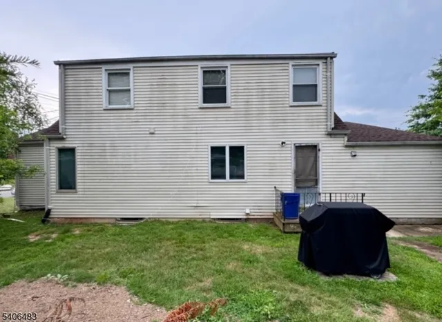 a view of house with backyard