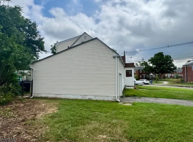 a view of backyard of house with green space