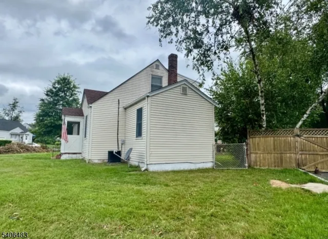 a view of a patio with table and chairs potted plants and a bench