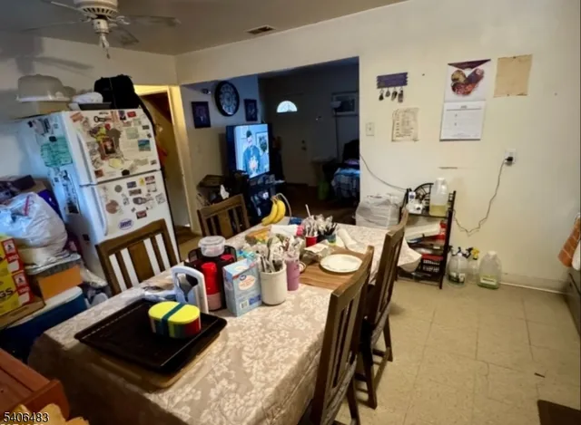 a view of a dining room with furniture and a chandelier