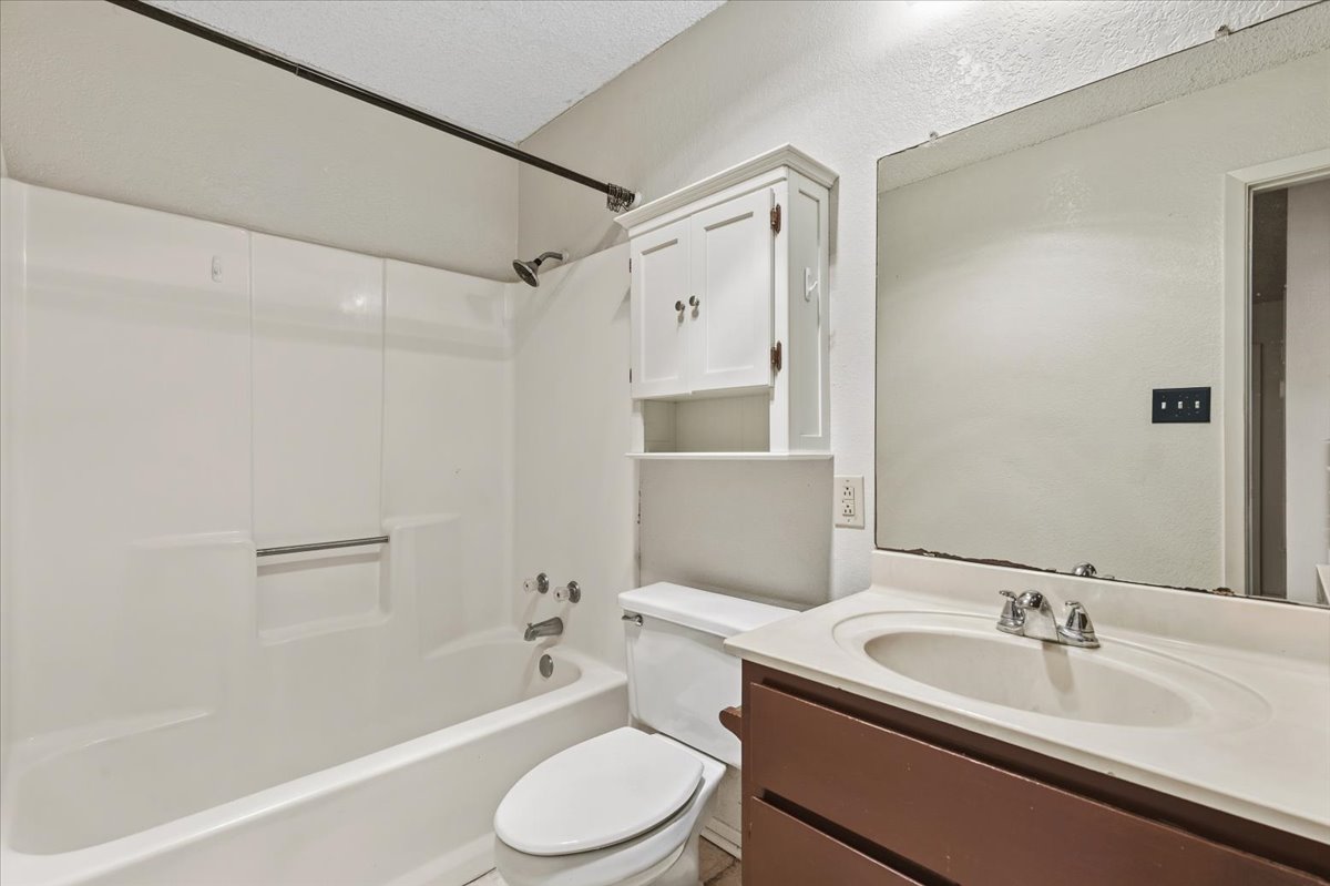 303 Ponderosa Road Bastrop, TX 78602 - Photo 17 of 34 a bathroom with a sink toilet and shower