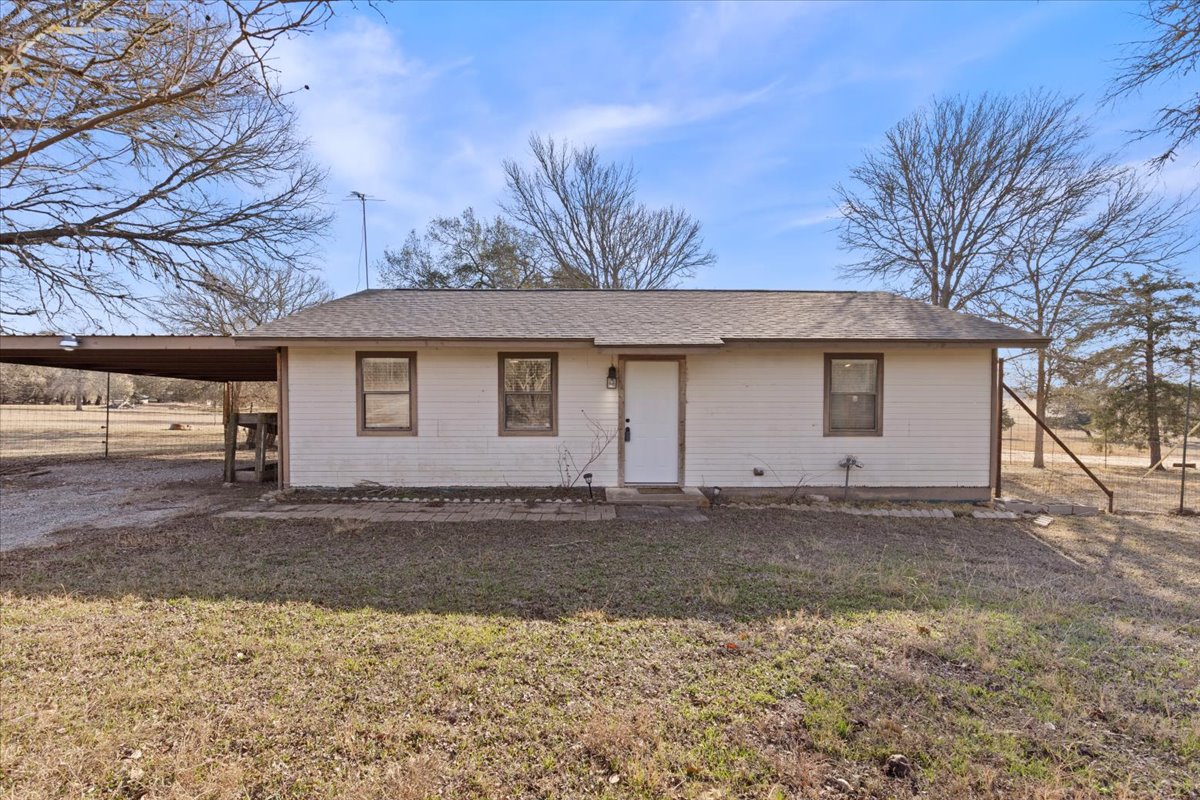 303 Ponderosa Road Bastrop, TX 78602 - Photo 2 of 34 a front view of a house with a yard