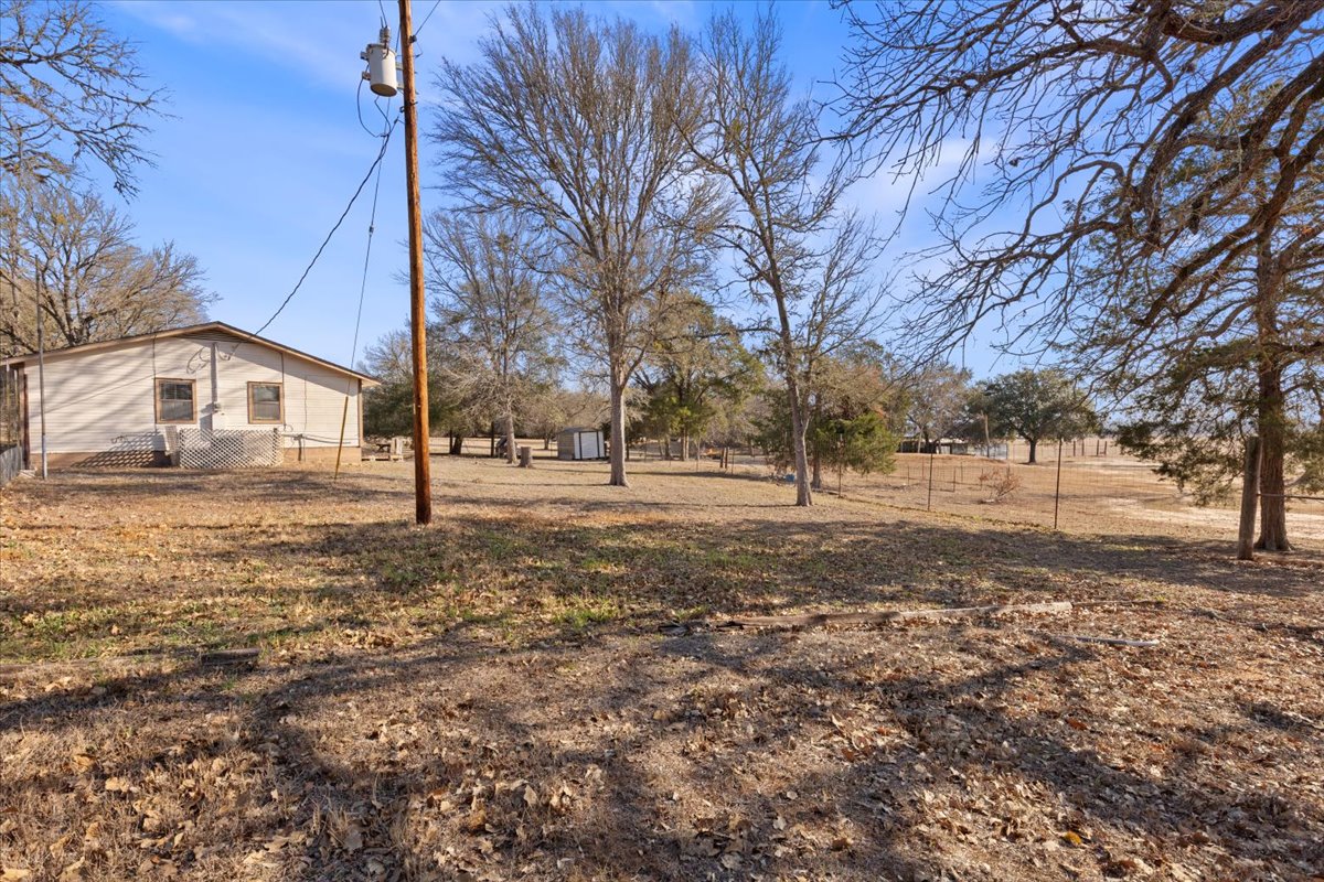 303 Ponderosa Road Bastrop, TX 78602 - Photo 24 of 34 a view of yard with trees