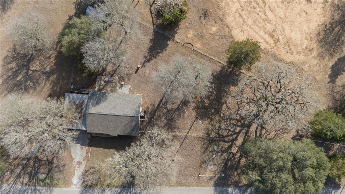 303 Ponderosa Road Bastrop, TX 78602 - Photo 26 of 34 a white house with a tree in the background
