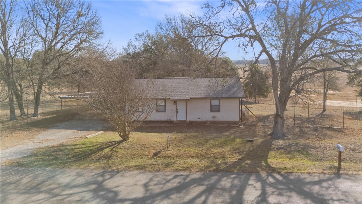 303 Ponderosa Road Bastrop, TX 78602 - Photo 28 of 34 a view of a house with a yard covered in snow