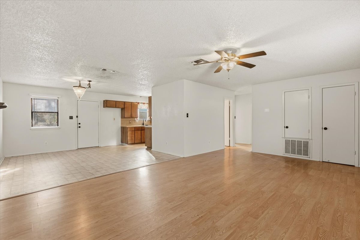 303 Ponderosa Road Bastrop, TX 78602 - Photo 7 of 34 wooden floor in an empty room with a window