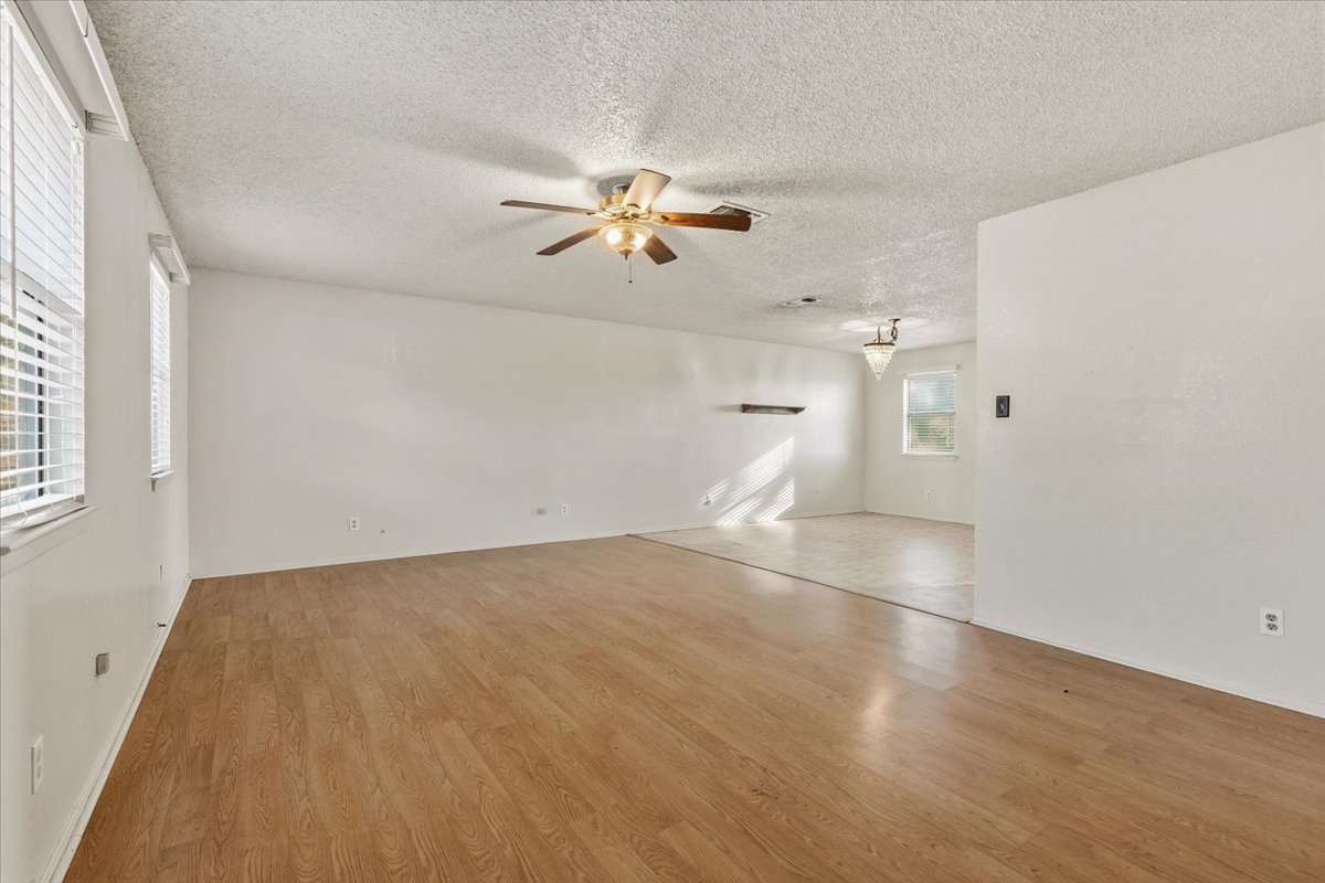 303 Ponderosa Road Bastrop, TX 78602 - Photo 8 of 34 wooden floor in an empty room with a window