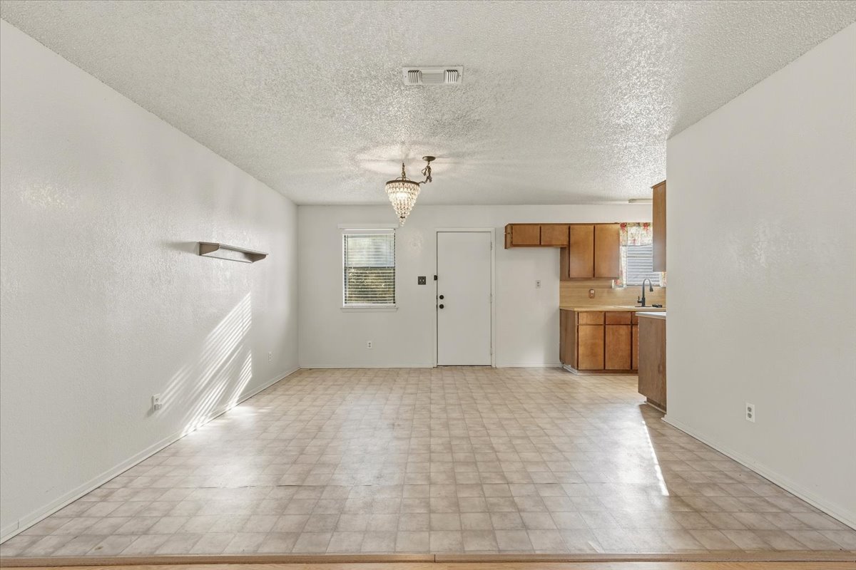 303 Ponderosa Road Bastrop, TX 78602 - Photo 9 of 34 a view of a kitchen with a sink and cabinet