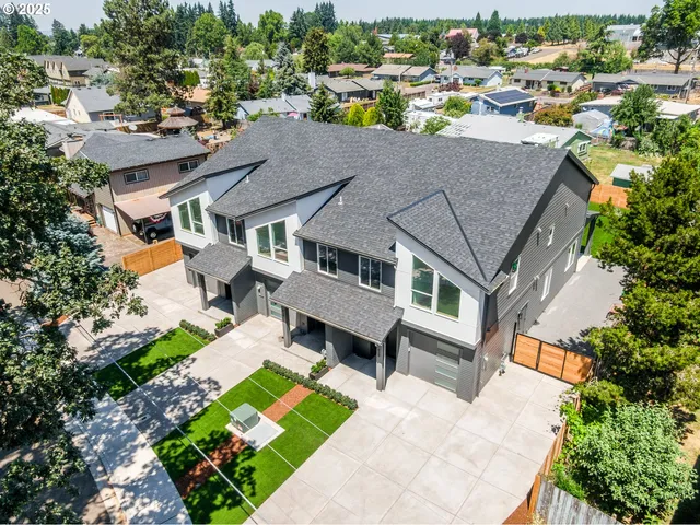 an aerial view of a house with a yard basket ball court and outdoor seating