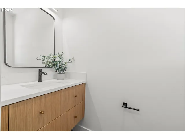 a bathroom with a double vanity sink and a mirror
