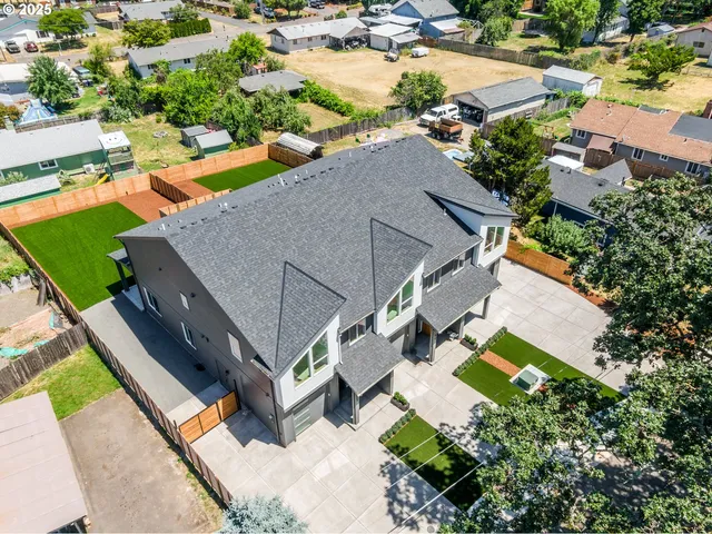 an aerial view of a house with a garden and swimming pool