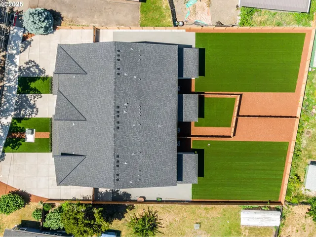 an aerial view of a house with a yard