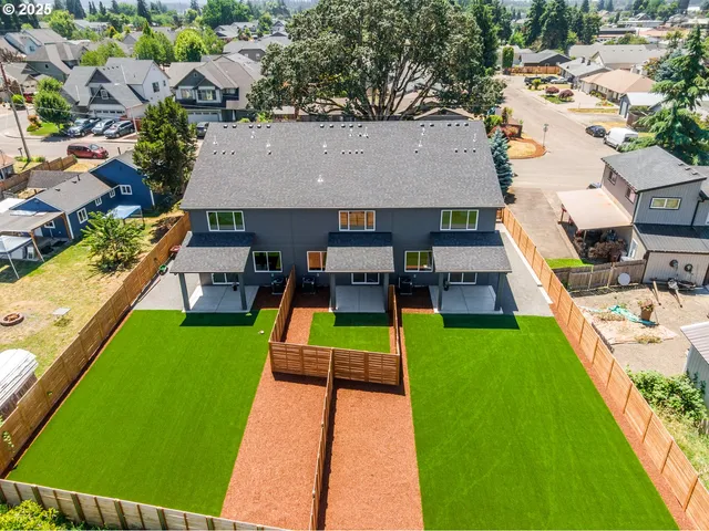 an aerial view of a house with swimming pool garden and patio