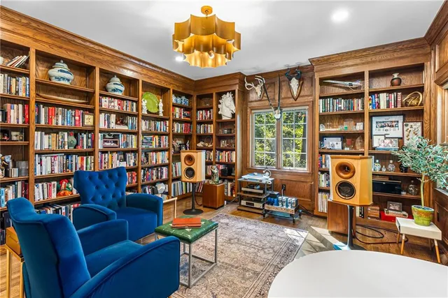 a living room with fireplace furniture and a book shelf