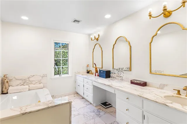 a bathroom with double vanity sinks and a mirror