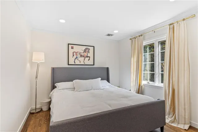 a bedroom with a large bed and a window