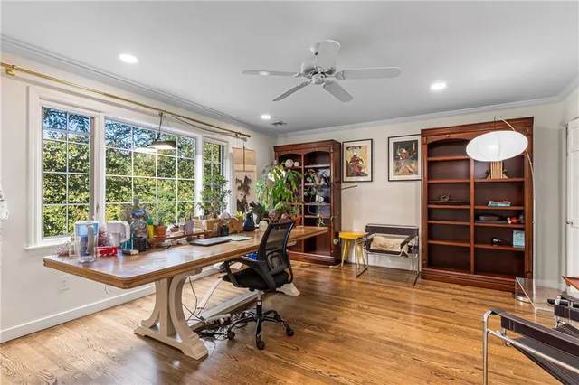 a view of a workspace with furniture and a window