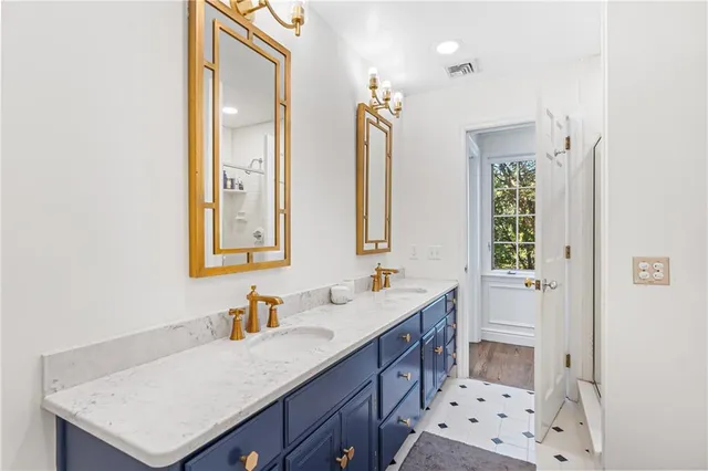 a bathroom with a sink mirror and a bathtub