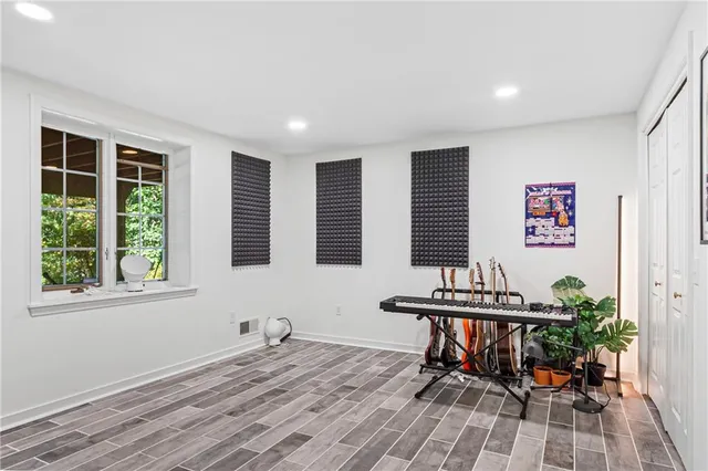 a view of a workspace with furniture and a window