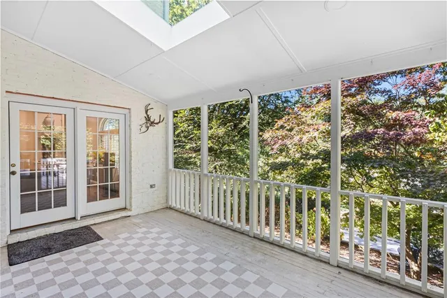 a view of a porch with wooden floor and fence
