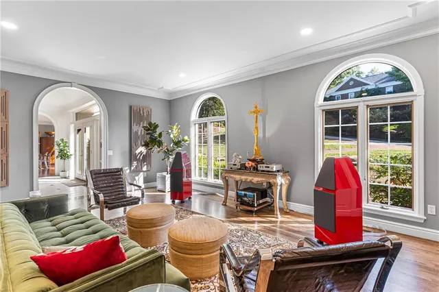 a living room with furniture and a floor to ceiling window