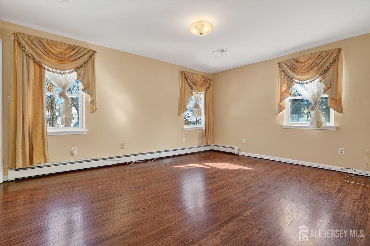 1 Wakefield Drive Edison, NJ 08820 - Photo 11 of 29 a view of an empty room with wooden floor and a window