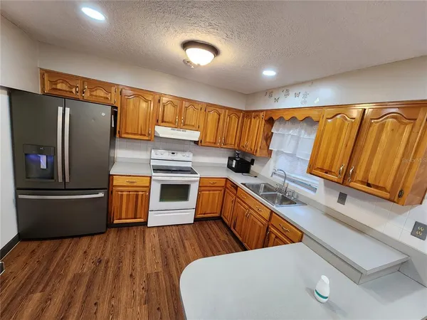 a kitchen with a sink cabinets and wooden floor